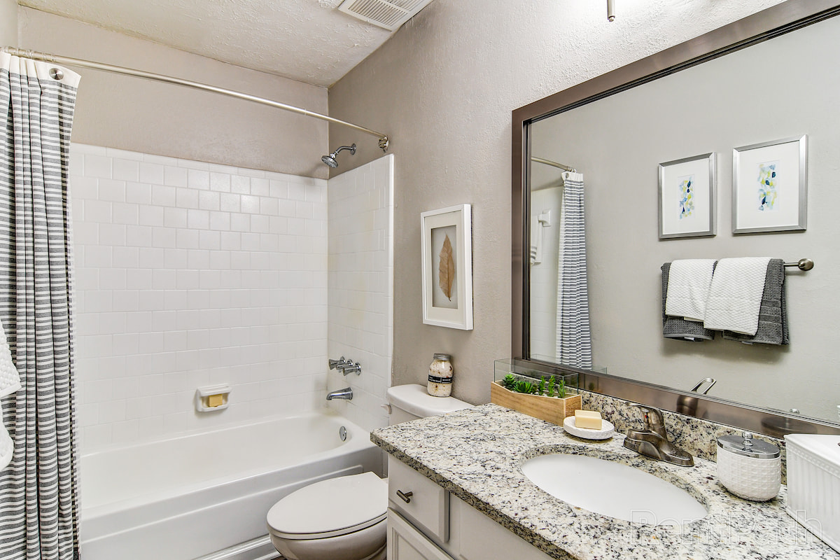 model bathroom with granite countertop and wall art