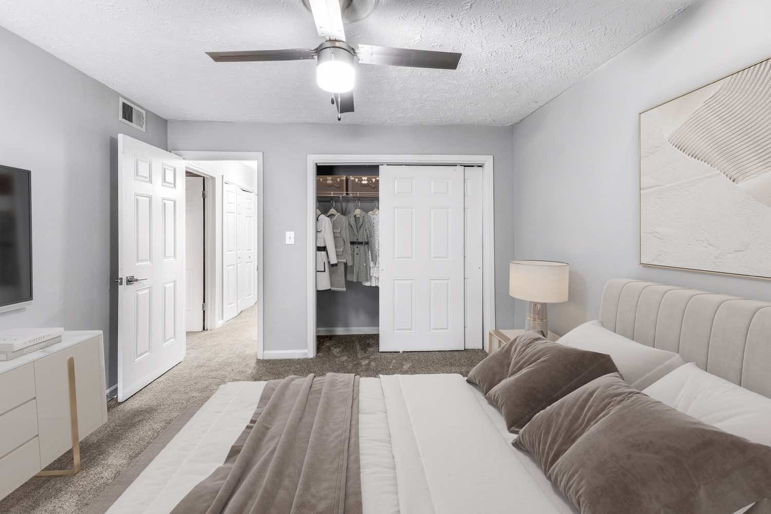 model bedroom with plush carpeting and ceiling fan