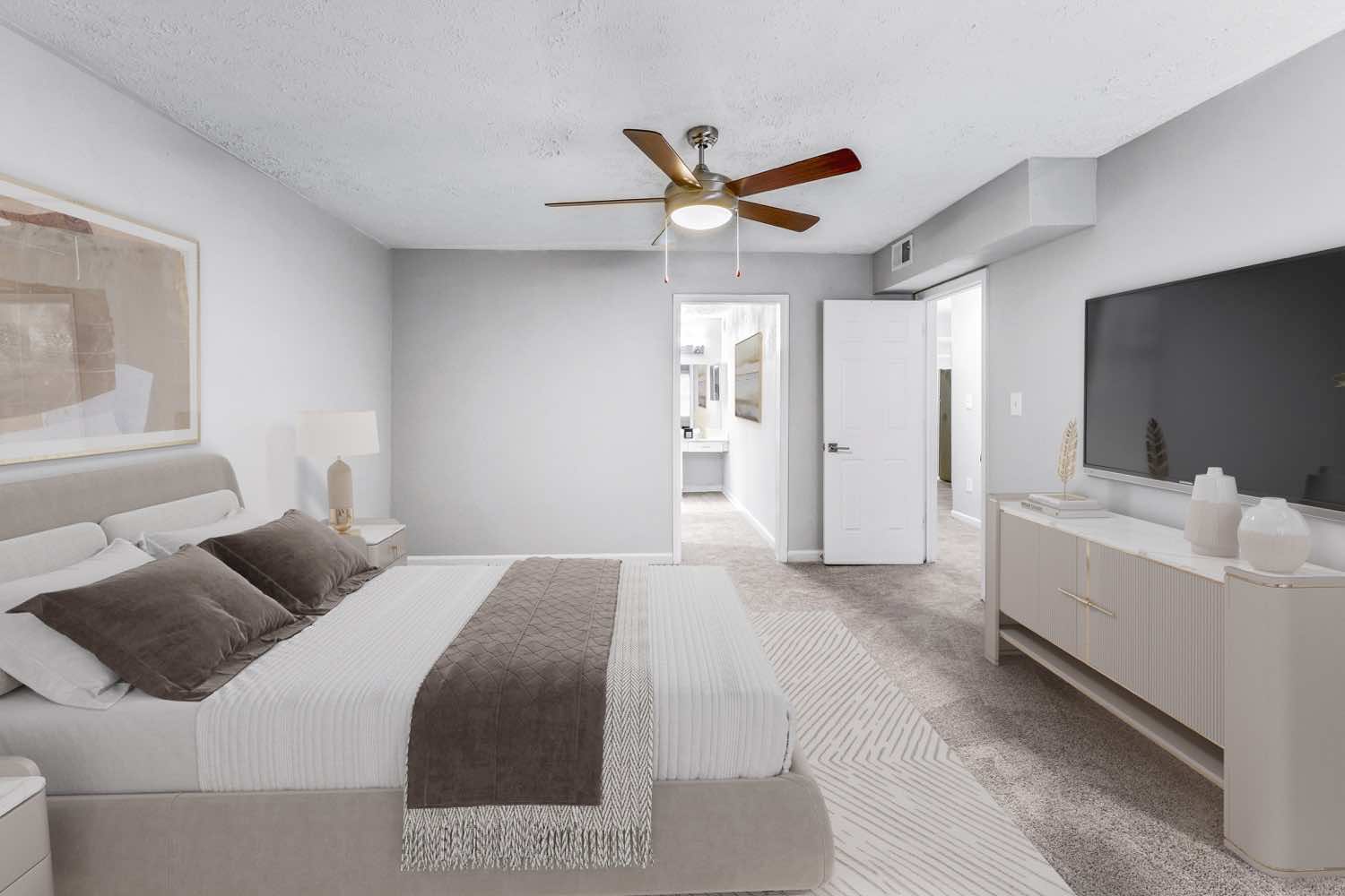 model bedroom with plush carpeting and ceiling fan