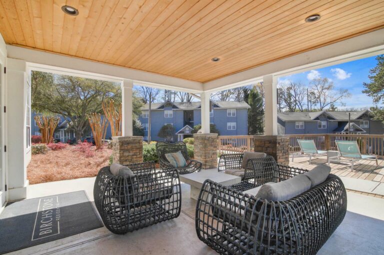 covered resident patio with large seating area and lounge chairs