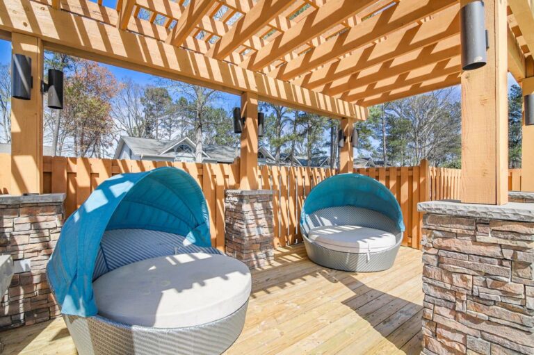 pergola with large canopy covered loveseats